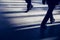 Modern lifestyle ground view of two busy men in different shoes walking with motion blur in urban city subway a weekday morning