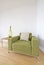 Modern living room detail with green armchair