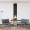 Modern living room with fireplace and armchair  empty wall mockup