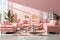 Modern Living Room Interior with Pink Colored Stylish Furniture and Cozy Ambiance