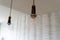 Modern looking kitchen hanging light fixtures inside a house features an exposed lightbulb