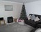 A Modern Lounge with Christmas Tree Decorated with presents at i