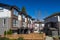 Modern low rise wood frame complex. Brand new apartment building on sunny day in spring with blooming trees.