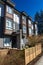 Modern low rise wood frame complex. Brand new apartment building on sunny day in spring with blooming trees.