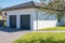 Modern and luxurious double garage with driveway and roller door