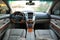 Modern luxury prestige car interior, dashboard, steering wheel. Perforated leather, wooden interior.
