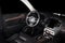 Modern luxury prestige car interior, dashboard, wood panels, steering wheel.