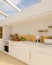 Modern luxury white kitchen interior with white kitchen cabinet and glass roof