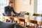 Modern man reading newspaper at his modern dining table