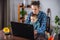 Modern man is working on a laptop, and his little son is sitting on his lap. Concept of family and remote work from home