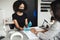 Modern manicure and health protection in beauty salon during epidemic. African american woman in protective mask and