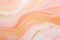 A modern marbling background featuring beautiful peach fuzz paint swirls with accents of gold powder.