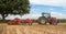 Modern massey ferguson tractor cultivating field