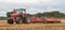 Modern massey ferguson tractor cultivating field