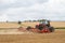 Modern massey ferguson tractor cultivating field