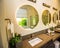 Modern Master Bathroom With Three Lighted Circular Mirrors