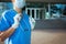 Modern medical doctor woman in scrubs outdoors near hospital