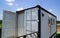 Modern metal building made from shipping house containers and blue sky background