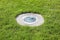 Modern metal spotlight led lamp for outdoor use of circular shape recessed in a grass area