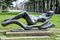 Modern metal statue of the naked girl in the park