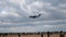 Modern military cargo plane flying on cloudy sky