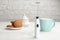 Modern milk frother, cup of coffee and cookies on table