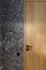 Modern minimalist bathroom dark interior design with dark stone tiles and wood door
