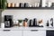 A modern, minimalist home coffee bar , featuring a sleek espresso machine, a collection of stylish mugs, and an assortment of