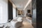 modern, minimalist living space with a streamlined design, featuring white sculptural chairs and a dark marble wall with