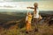 Modern mother and child hikers pointing at something