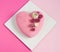 Modern  mousse cake .Heart shape  cake covered with pink chocolate velour and decoraited of pink roses.Pink background. Concept