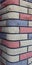 Modern multicolored brick column, background texture, close-up