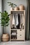 A modern neat wardrobe with neutrals reflects and colors in Japandi style, emphasizing sustainability with natural