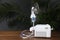 Modern nebulizer with face mask on wooden table indoors, space for text. Inhalation equipment