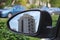 Modern new apartment building in Israel reflected in the side mirror of the car. Real Estate in Israel: buying, selling, renting