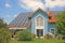 Modern new built house and garden, rooftop with solar cells, blu