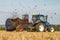 Modern New Holland tractor Tractor spreading manure on fields