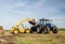 Modern New Holland tractor Tractor spreading manure on fields