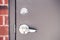 Modern new metallic grey shiny keyhole on door background. Front view of key lock and door handle