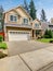 Modern northwest home with tan exterior, and garage.