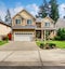 Modern northwest home with tan exterior, and garage.