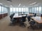 modern office boardroom and meeting room interior with desks, chairs and cityscape view.