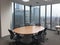 modern office boardroom and meeting room interior with desks, chairs and cityscape view.