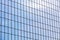 Modern office building facade. glass wall reflecting blue sky.