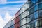 Modern Office Building with Glass Windows against Blue Sky for Business Images