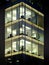 modern office building illuminated at night with geometric windows