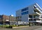 Modern office building next to large metal sign saying Welcome to Bremen in four languages