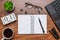 Modern office workplace with laptop keyboard, coffee cup, smart phone, stationery and plant. Date 01 March on wooden block