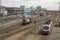 Modern and old train at the railway station on the background of buildings and empty railway tracks