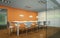 Modern orange dining room interior design big table behind glas